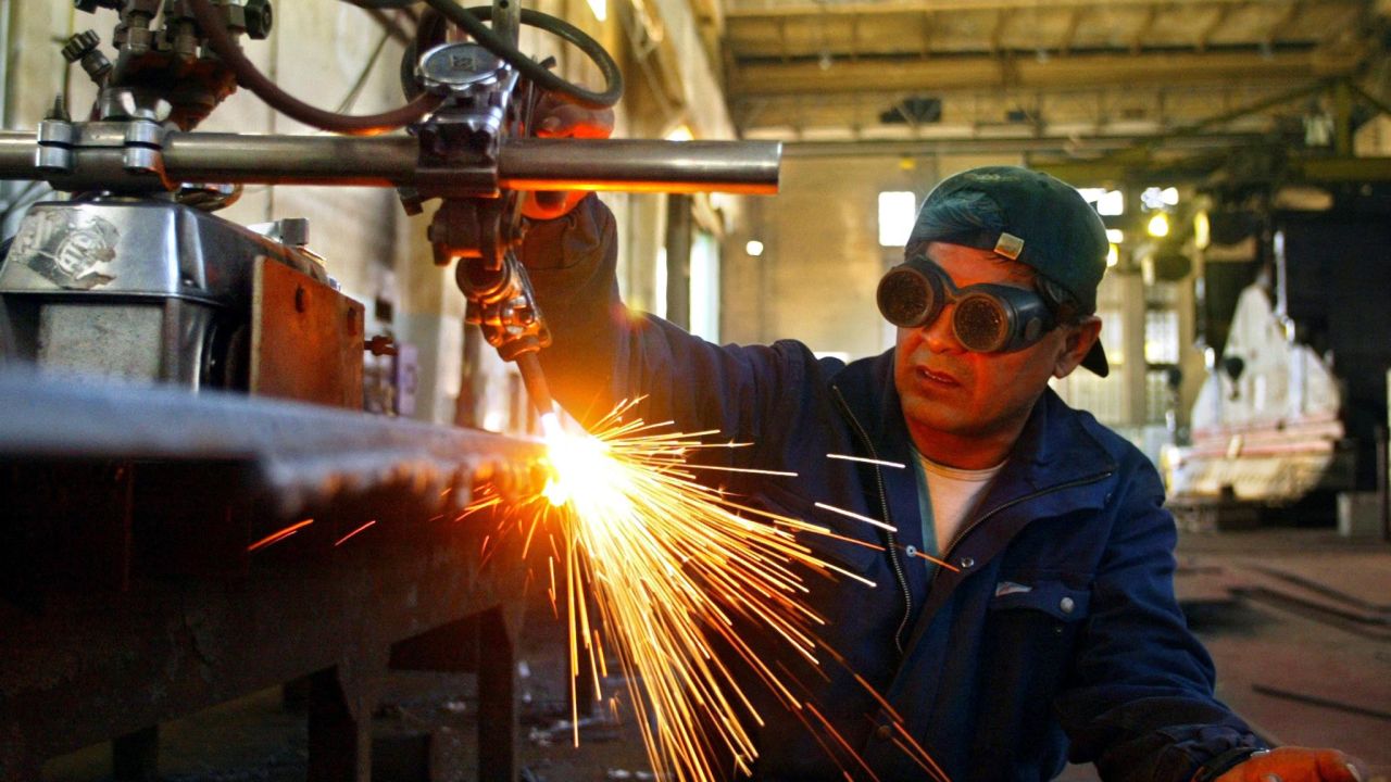 Ruiz Fortunato, a worker of the Rio Santiago shipyard cuts a steel sheet in Ensenada La Plata (50 km from Buenos Aires), Argentina, 26 July 2004. Rio Santiago, the biggest shipyard in Latin America, provides 2,300 jobs. Last July 23, Argentina's President Nestor Kirchner signed in Venezuela, an agreement with the state-owned company Dianca, to repair an oil tanker and eventually, to build 8 more Panamax tankers for PDVSA (state-owned).   AFP PHOTO/Ali BURAFI (Photo by ALI BURAFI / AFP) (Photo by ALI BURAFI/AFP via Getty Images)