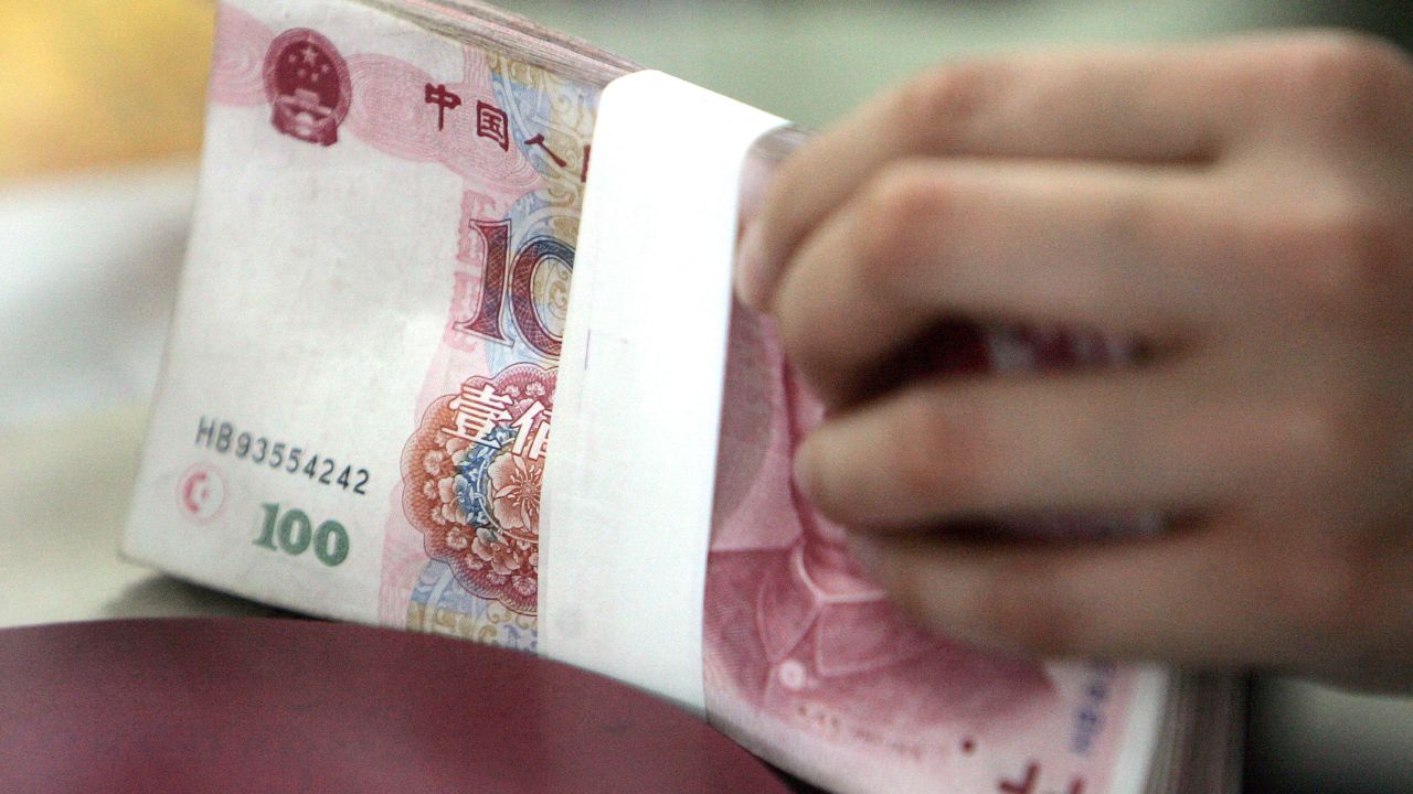 A stack of hundred yuan notes is counted at a local bank in Beijing, 15 May 2006.  China set its currency, the yuan, at 7.9982 to the US dollar early 15 May, the first time since a revaluation last year that it broke below the psychologically important 8.000 mark.     AFP PHOTO/GOH CHAI HIN (Photo by AFP) (Photo by -/AFP via Getty Images)