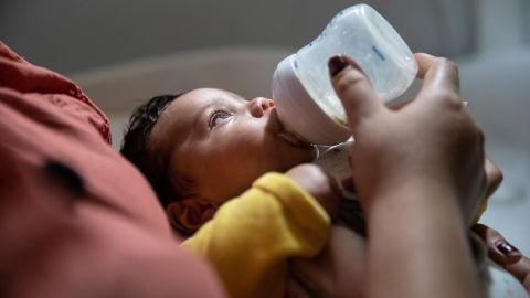 STAMFORD, CONNECTICUT - JUNE 17: Zully prepares her son Neysel, 10 weeks, for bed on June 17, 2020 in Stamford, Connecticut. On April 1 Zully, then almost 8 months pregnant, was hospitalized for Covid-19 at Stamford Hospital, where she was intubated and given an emergency C-section. Neysel was born healthy but could not  his father Marvin and brother Junior, (right), as they were both Covid positive and quarantined at home. The newborn stayed for six weeks in the care of  Luciana Lira, Junior's K-5 Bilingual /ESL instructor, until the family recovered and tested Covid-negative. After more than three weeks in a coma at the hospital ICU, Zully responded to experimental antibody blood plasma transfusions and was able to return home. A GoFundme campaign raised $53,832 for the Guatemalan immigrant family, who has also been assisted by the Stamford non-profit Building One Community.  (Photo by John Moore/Getty Images)
