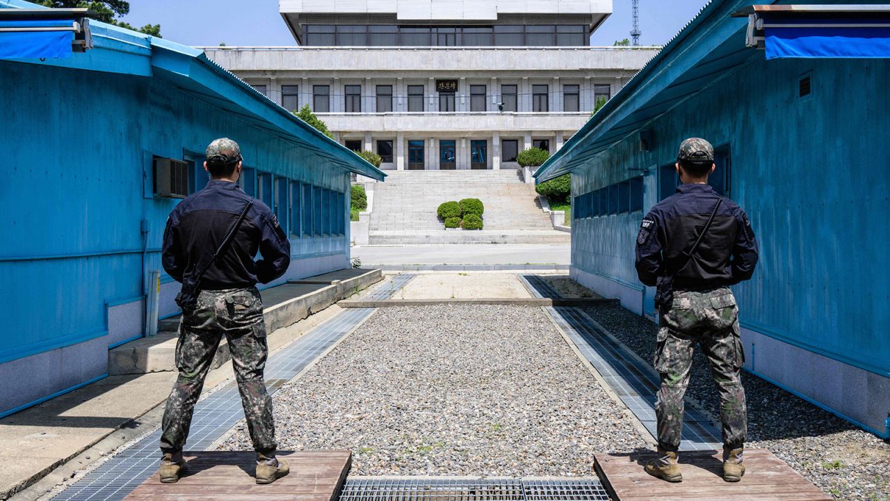 In this photo taken on May 9, 2023, South Korean soldiers stand guard as they face North Korea's Panmon Hall (back) at the truce village of Panmunjom in the Joint Security Area (JSA) of the Demilitarized Zone (DMZ) separating North and South Korea.