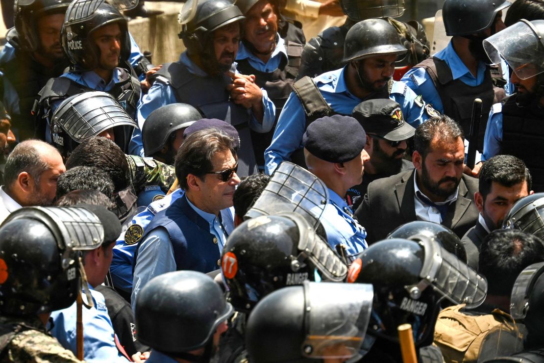 Policemen escort Khan as he arrives for a bail hearing at the high court in Islamabad on May 12, 2023.