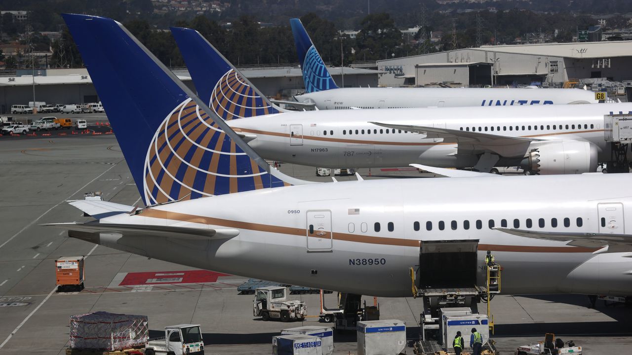 United Airlines workers load cargo onto a plane at San Francisco International Airport on July 8, 2020 in San Francisco, California.