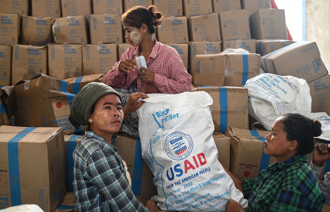 Workers sort through food at a damaged UN World Food Programme warehouse in Sittwe.