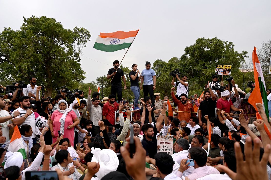 From right: Indian wrestlers Sakshi Malik, Vinesh Phogat and Bajrang Punia speak during a candlelight vigil to protest the sport's local federation chief, over allegations of sexual harassment, in New Delhi on May 23, 2023.