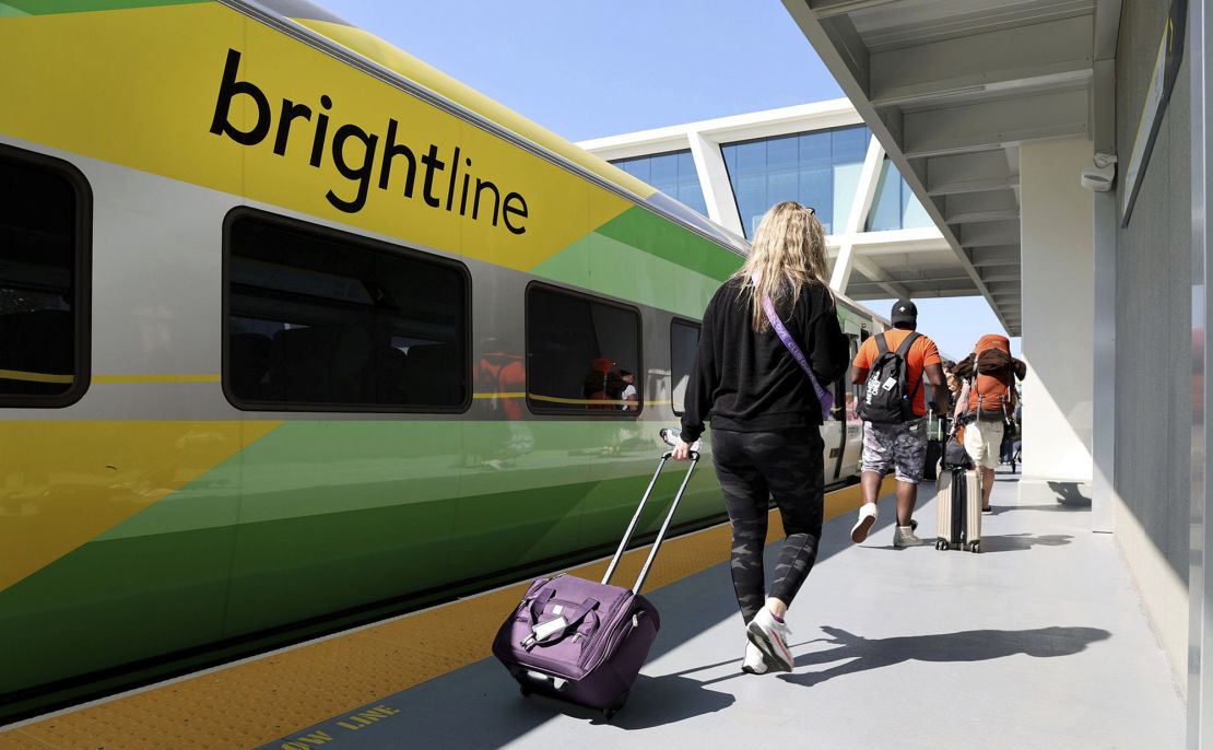 Passengers load a Brightline train to West Palm Beach at the Fort Lauderdale station on Feb. 27, 2023, in Florida. The privately owned high-speed rail network plans a Los Angeles to Las Vegas route.
