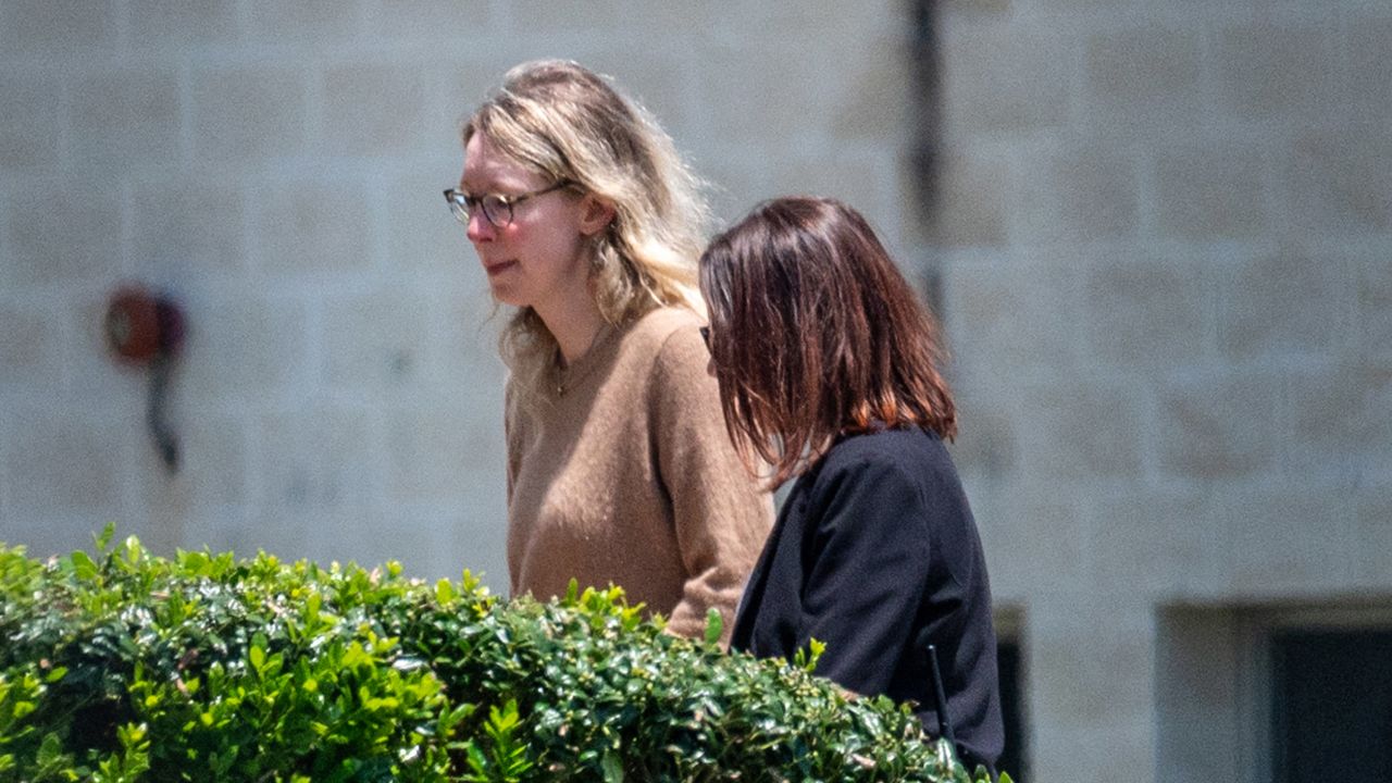 Elizabeth Holmes, founder of Theranos Inc., left, arrives at Federal Prison Camp Bryan in Bryan, Texas, US, on Tuesday, May 30, 2023. Holmes surrendered to authorities on Tuesday to begin her 11 1/4-year sentence after she was convicted by a jury last year of defrauding investors in the blood-testing startup. Photographer: Sergio Flores/Bloomberg via Getty Images
