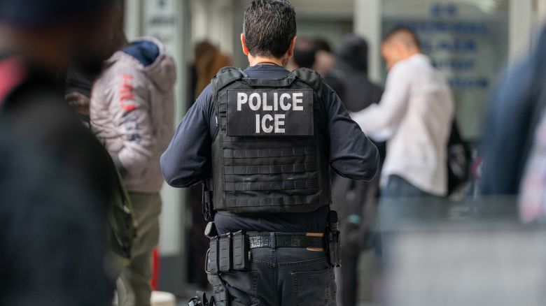 NEW YORK, NEW YORK - JUNE 6: An ICE agent monitors hundreds of asylum seekers being processed upon entering the Jacob K. Javits Federal Building on June 6, 2023 in New York City. New York City has provided sanctuary to over 46,000 asylum seekers since 2013, when the city ed a law prohibiting city agencies from cooperating with federal immigration enforcement agencies unless there is a warrant for the person's arrest.(Photo by David Dee Delgado/Getty Images)