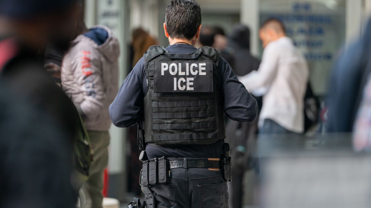 NEW YORK, NEW YORK - JUNE 6: An ICE agent monitors hundreds of asylum seekers being processed upon entering the Jacob K. Javits Federal Building on June 6, 2023 in New York City. New York City has provided sanctuary to over 46,000 asylum seekers since 2013, when the city ed a law prohibiting city agencies from cooperating with federal immigration enforcement agencies unless there is a warrant for the person's arrest.(Photo by David Dee Delgado/Getty Images)