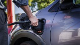 A driver charges a Chevy Bolt electric vehicle at a Tesla Supercharger in Scotts Valley, California, US, on Thursday, June 1, 2023. Tesla is making its ubiquitous Superchargers available to other EVs through new corporate partnerships and its Magic Dock.