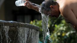 TOPSHOT - A man cools himself down with water from a water fountain during one of the hottest days of the third heat wave in Guadalajara, Jalisco state, Mexico, on June 12, 2023. (Photo by ULISES RUIZ / AFP) (Photo by ULISES RUIZ/AFP via Getty Images)