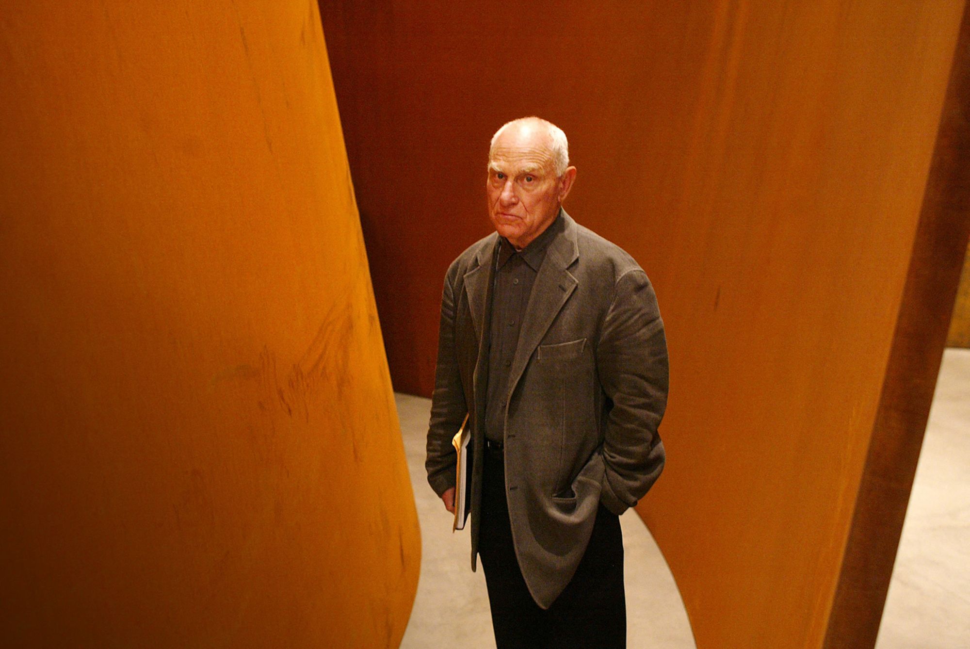 Sculptor Richard Serra poses in front of one of his works featured at the Guggenheim Bilbao Museum exhibition, "The Matter of Time" in 2005.