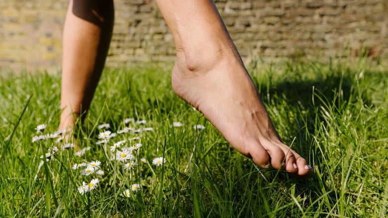 Feet of a woman walking in grass