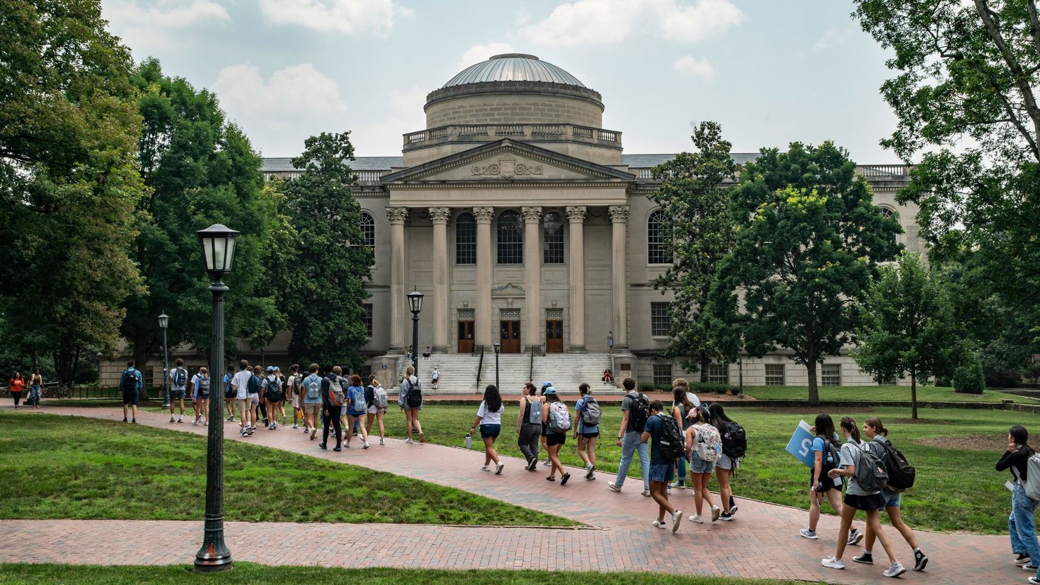 People walk on the campus of the University of North Carolina at Chapel Hill on June 29, 2023.