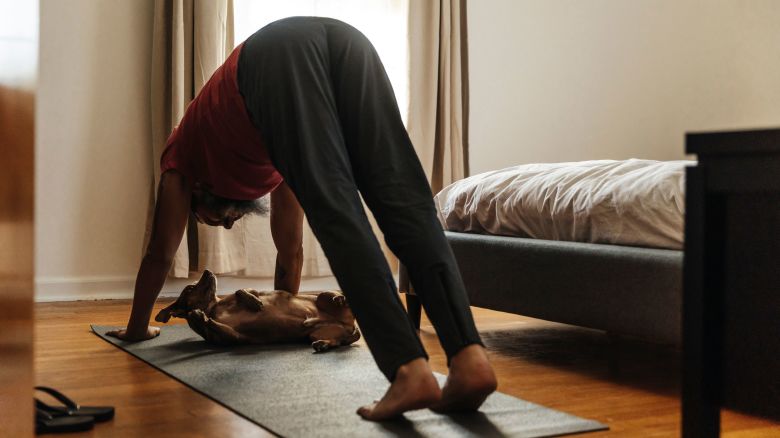 Man practicing yoga in bedroom - stock photo