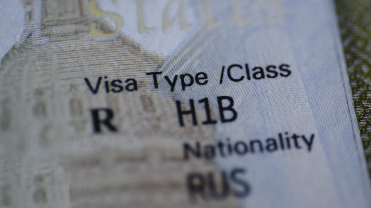A close-up view of the H1B visa stamp in a passport.
