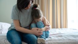 Loving young mother touching upset little daughter, expressing support, young mum comforting offended adorable preschool girl,