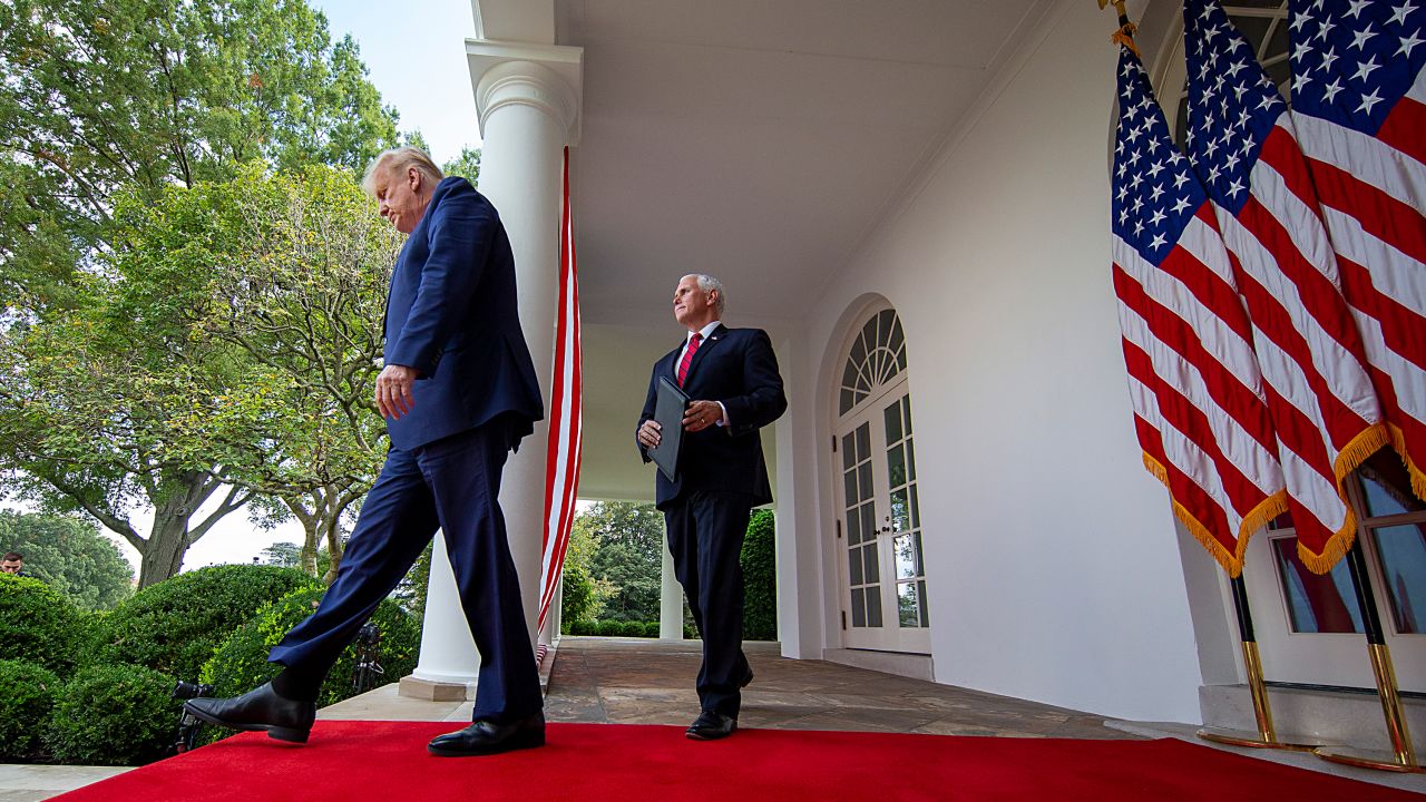 US President Donald Trump followed by Vice President Mike Pence in the Rose Garden of the White House on September 28, 2020, in Washington, DC.