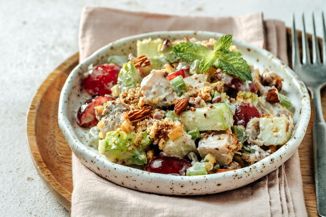 Waldorf salad features apples, celery, grapes and bits of chicken, dressed mayonnaise.