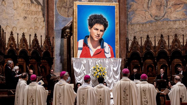 A tapestry featuring a portrait of Carlo Acutis is hang at the St. Francis Basilica during the beatification ceremony of Carlo Acutis, on October 10, 2020 in Assisi, Italy. The fifteen-year-old Carlo Acutis member of the Millennial generation who died on 12 October 2006 from M3 fulminant leukemia, is considered a "computer geek" on account of his passion and skill with computers and the internet. Acutis applied himself to creating a website dedicated to cataloguing each reported Eucharistic miracle in the world.