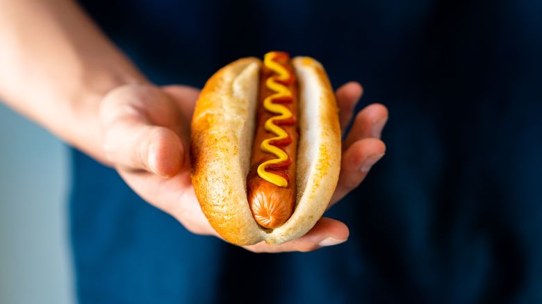 Hot dog with fresh organic bread bun white wheat and black charcoal sausage ketchup mustard