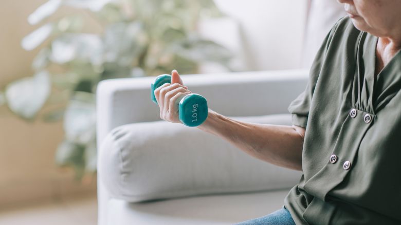 asia chinese Senior women taking care of herself she exercise with dumbbells at home