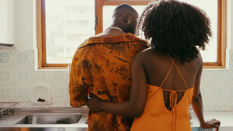 Shot of a young couple sharing a romantic moment while washing the dishes at home
