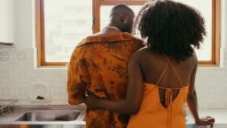Shot of a young couple sharing a romantic moment while washing the dishes at home