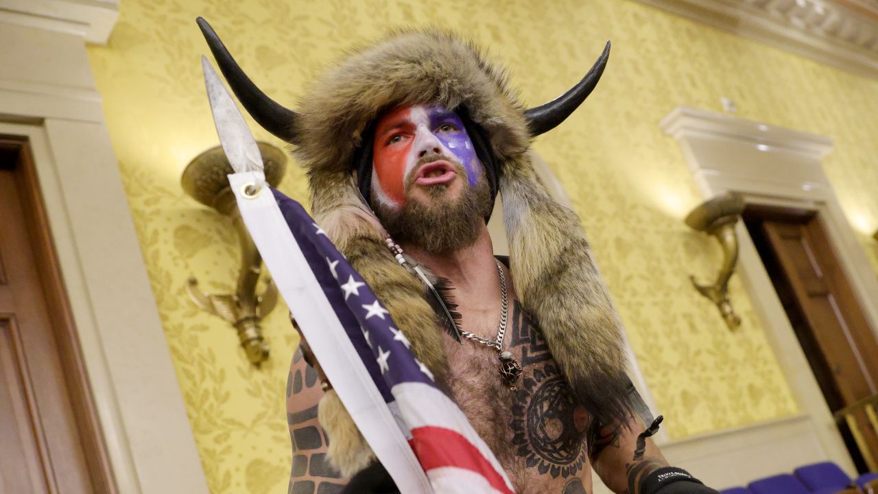 WASHINGTON, DC - JANUARY 06: A protester yells inside the Senate Chamber on January 06, 2021 in Washington, DC. Congress held a joint session today to ratify President-elect Joe Biden's 306-232 Electoral College win over President Donald Trump. Pro-Trump protesters entered the U.S. Capitol building during mass demonstrations in the nation's capital. (Photo by Win McNamee/Getty Images)