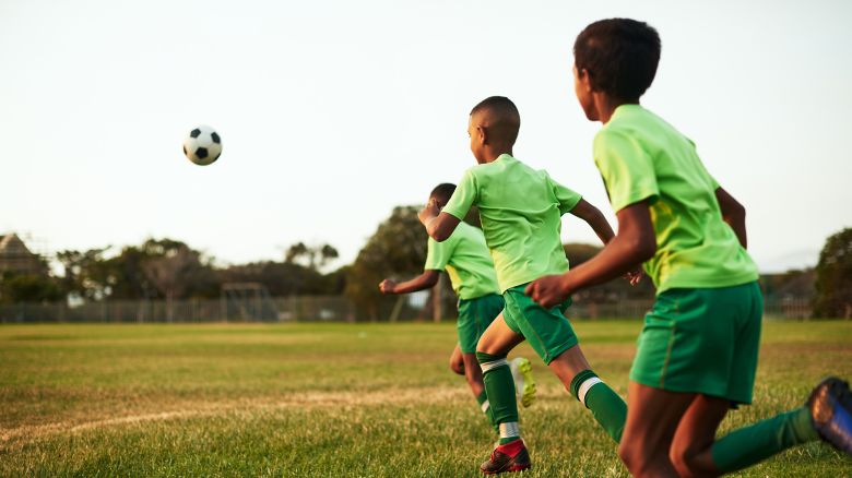 Shot of a group of young boys playing soccer on a sports field