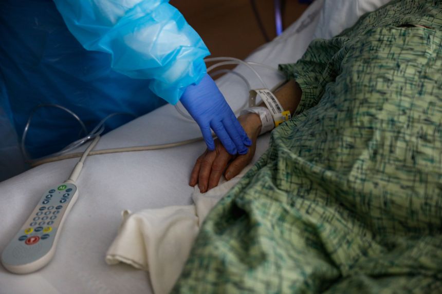 A nurse checks on a patient at Regional Medical Center of San Jose, an acute-care hospital, in December 2020 in San Jose, California.