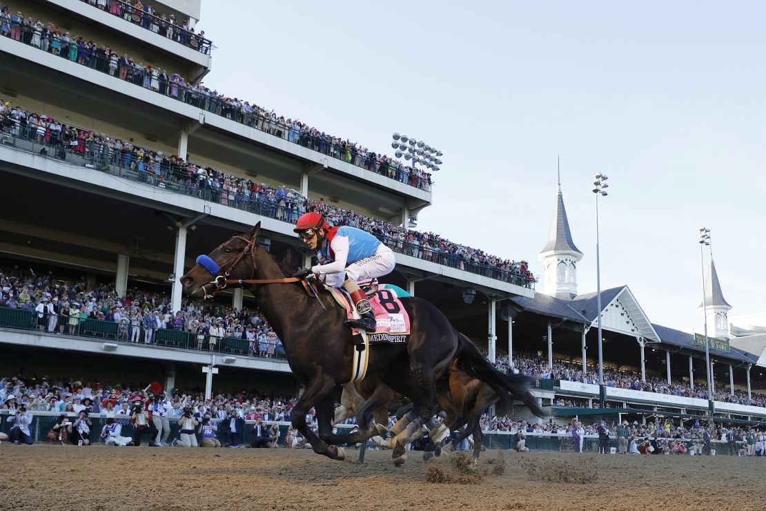 Medina Spirit, ridden by jockey John Velazquez, crosses the finish line to win the 147th running of the Kentucky Derby.