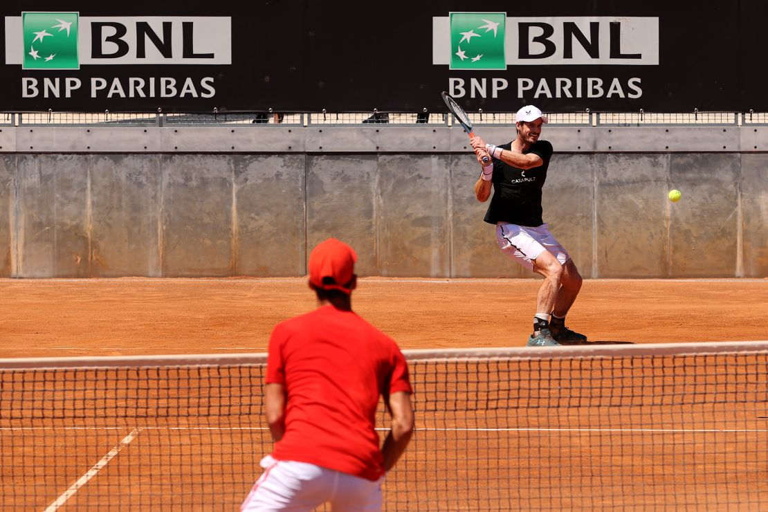 Andy Murray returns a backhand to Novak Djokovic during a practice session in 2021.