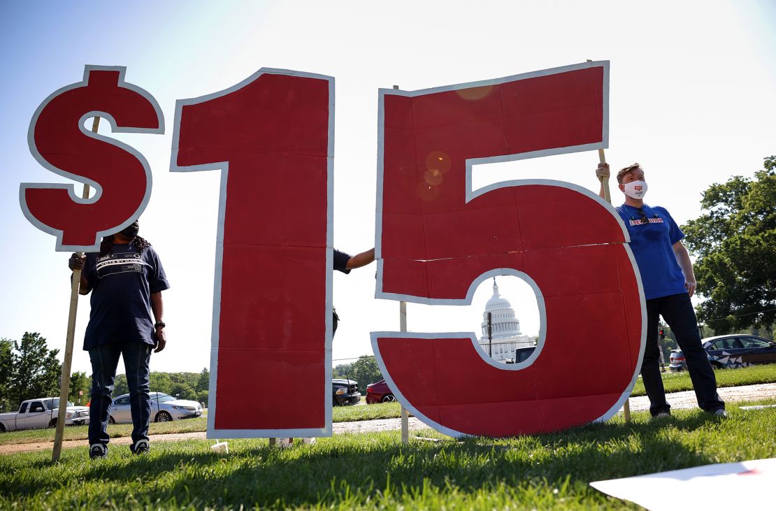 Labor activists hold a rally in support of raising the minimum wage to $15 an hour on the National Mall on May 19, 2021 in Washington, DC. Members of the Service Employee International Union organized the rally in support of striking McDonald's workers demanding a wage increase.