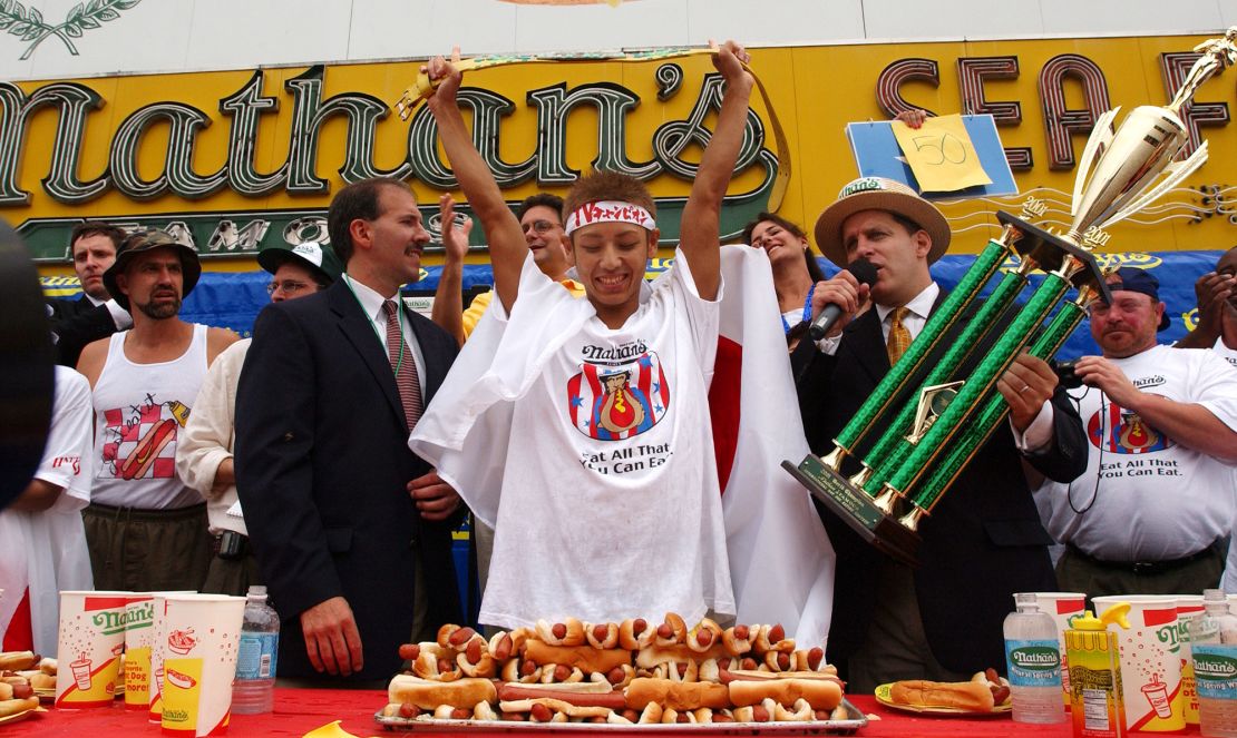 Twenty-three year-old Takeru Kobayashi of Japan raises his hands in victory July 4, 2001 at the 86th annual Nathan's Famous International 4th of July Hot Dog Eating Contest at Coney Island in Brooklyn, NY. Kobayashi, who was the odds on favorite, broke the world record of 25 and 1/8 set by fellow countryman Kazutoyo Arai by eating 50 hot dogs in 12 minutes.