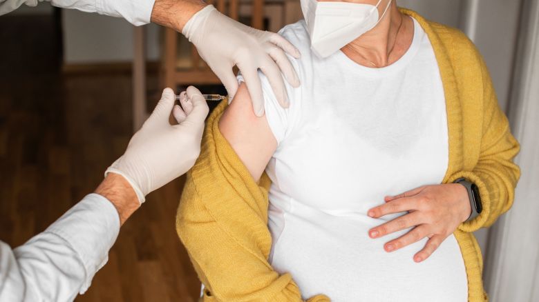 Pregnant woman taking a vaccination