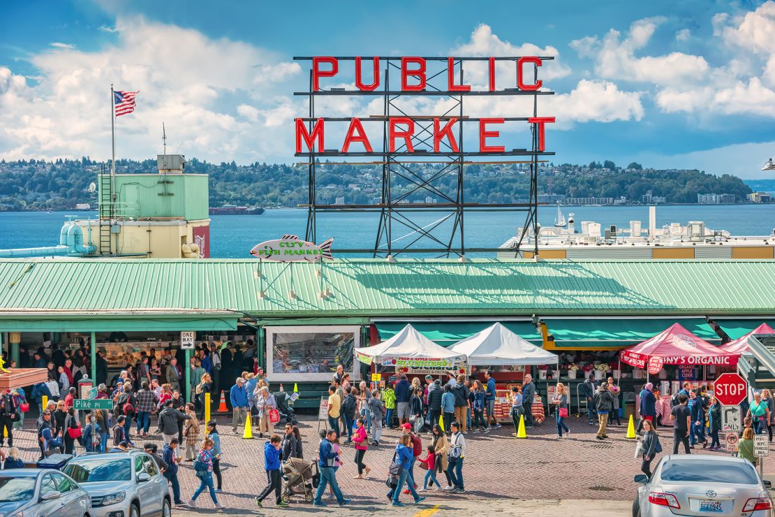 People walk through Pike Place Market in Seattle. Washington state's largest city is the No. 1 Labor Day destination, according to AAA.