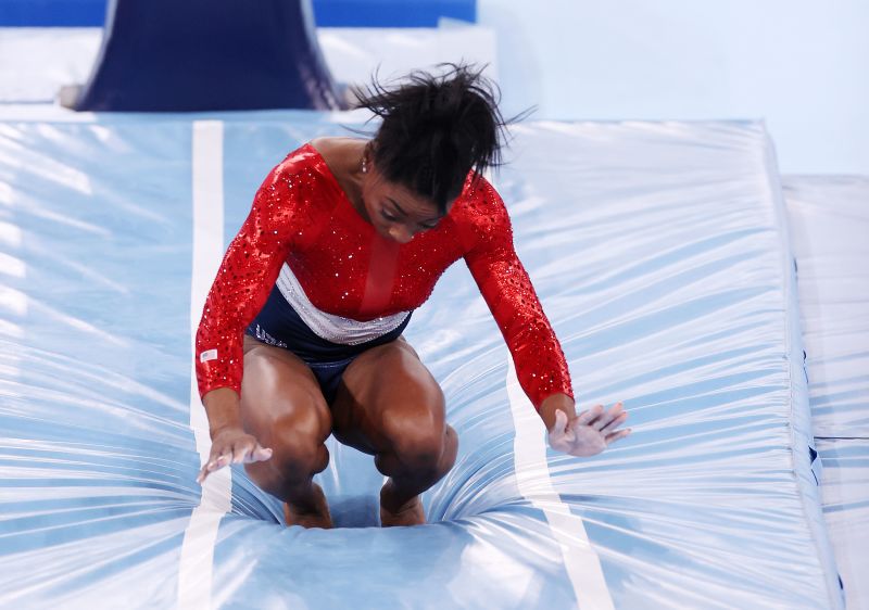 TOKYO, JAPAN - JULY 27: Simone Biles of Team United States stumbles upon landing after competing in vault during the Women's Team Final on day four of the Tokyo 2020 Olympic Games at Ariake Gymnastics Centre on July 27, 2021 in Tokyo, Japan. (Photo by Jamie Squire/Getty Images)
