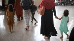 Refugees arrive at Dulles International Airport in Dulles, Virginia, after being evacuated from Kabul following the Taliban takeover of Afghanistan on August 27, 2021.