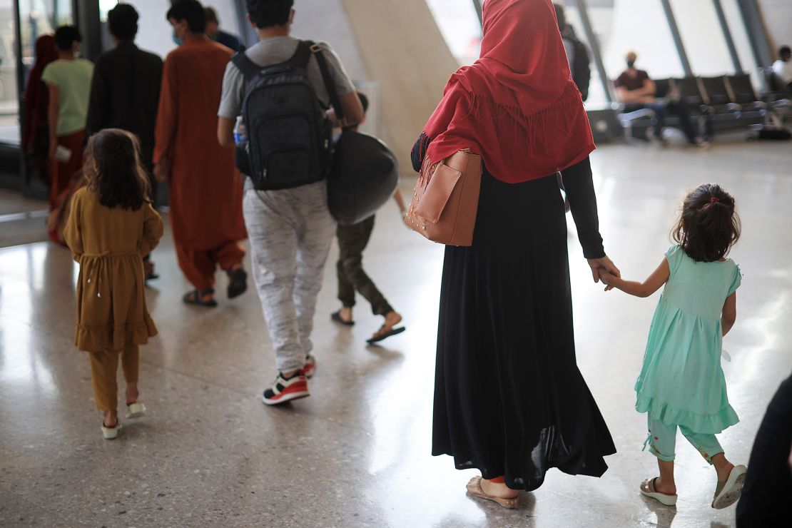 Refugees arrive at Dulles International Airport after being evacuated from Kabul following the Taliban takeover of Afghanistan August 27, 2021.