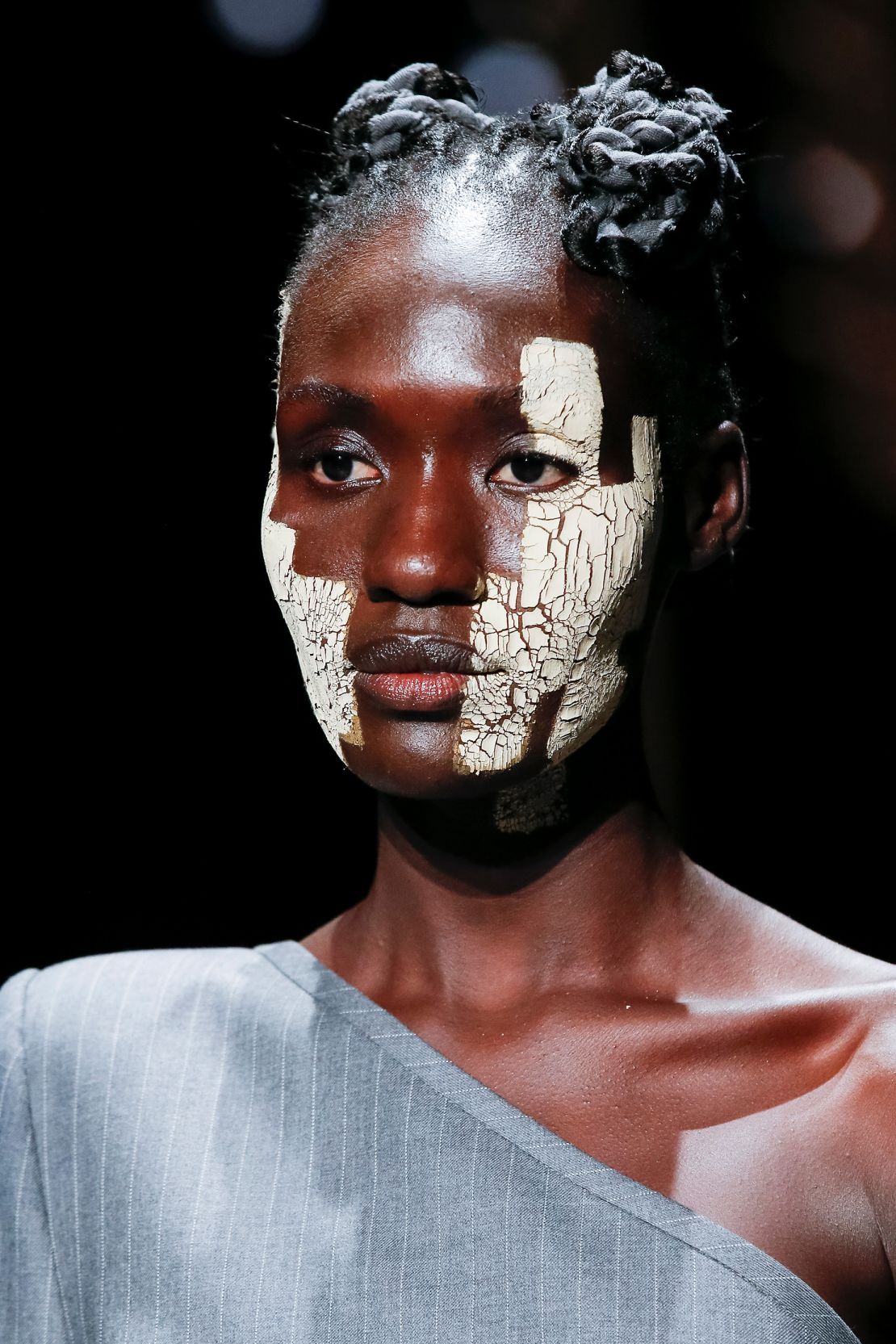 Cracking strokes of clay were brushed across models' faces at the Thom Browne show at New York Fashion Week in 2021.