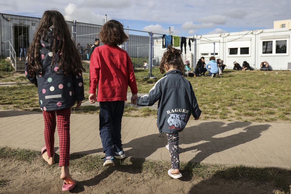 Children walk near a holding facility for irregular migrants on October 06, 2021 in Eisenhuttenstadt, Germany.