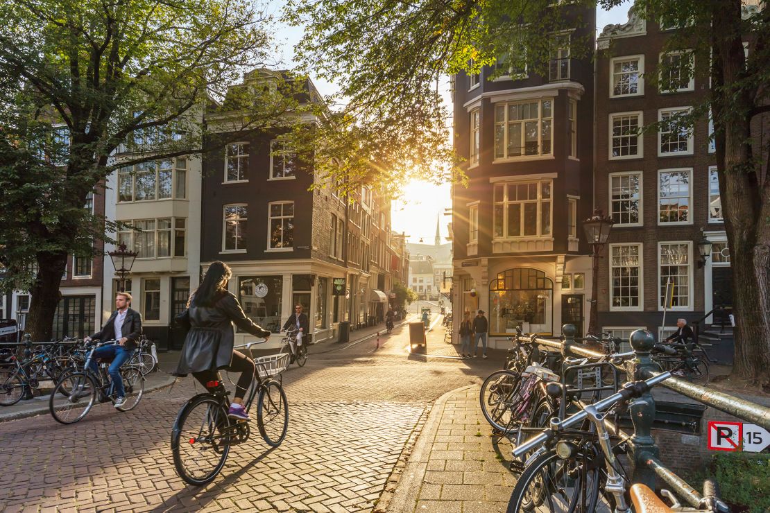 The Netherlands is among the happiest countries on the planet, according to pollsters Gallup. Bicyclists are sure to be at home in Amsterdam (above) and other cities in the Netherlands.