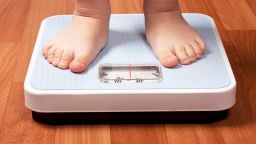 Closeup view of scales on a floor and kids feet