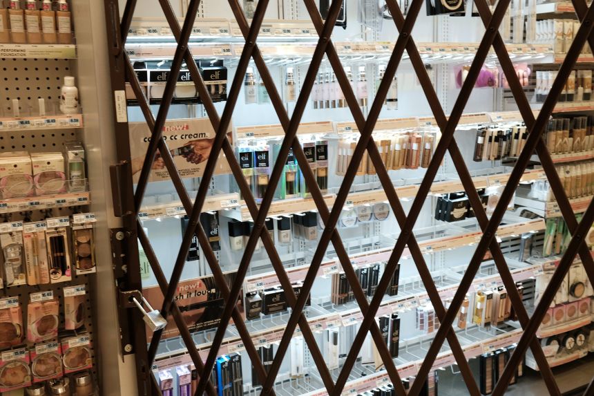 A gate is used to lock items at a pharmacy and convenience store in October 2021 in New York City.