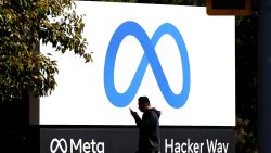 MENLO PARK, CALIFORNIA - OCTOBER 28: A pedestrian walks in front of a new logo and the name 'Meta' on the sign in front of Facebook headquarters on October 28, 2021 in Menlo Park, California. A new name and logo were unveiled at Facebook headquarters after a much anticipated name change for the social media platform. (Photo by Justin Sullivan/Getty Images)