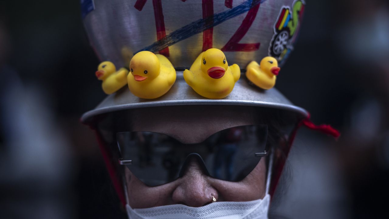 A protester with a metal jug with "abolish section 112 Lese majeste law" written on at the anti-government gathering in downtown on October 31, 2021 in Bangkok, Thailand.