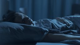 Woman sleeping in her bed at night, healthy lifestyle concept