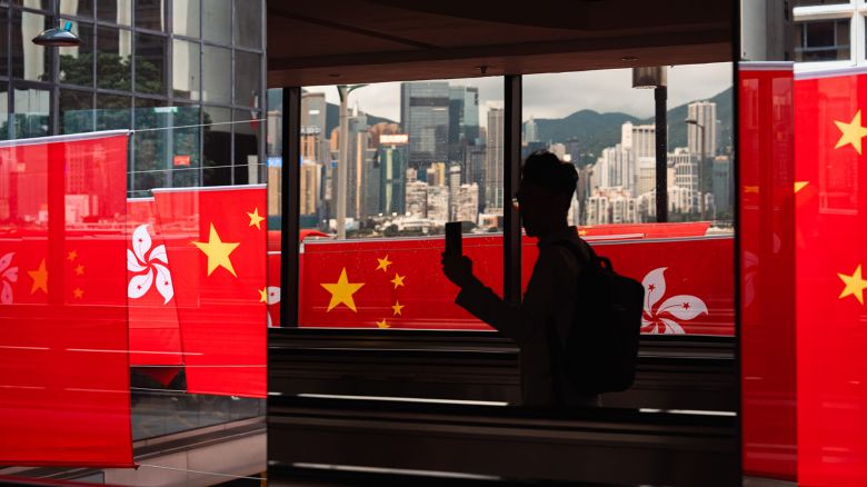 A man takes pictures of Chinese and Hong Kong flags during the 26th anniversary of the Hong Kong's handover to China, in Hong Kong, China on June 29, 2023.