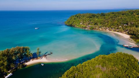 Headland of Hat Klong Chao Beach at Koh Kood (Ko Kut) island where the canal of Klong Chao conjuncts with the sea with clear turquoise water and white sand beach that flooded with water during high tide. High angle view. - stock photo