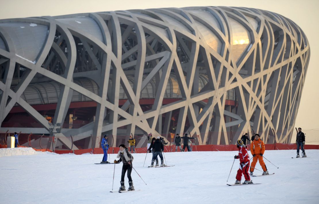 People ski on a slope in front of China's National Stadium, also known as the Bird's Nest, in Beijing on January 7, 2010. The structure was designed by Arup for the 2008 Summer Olympics and Paralympics.